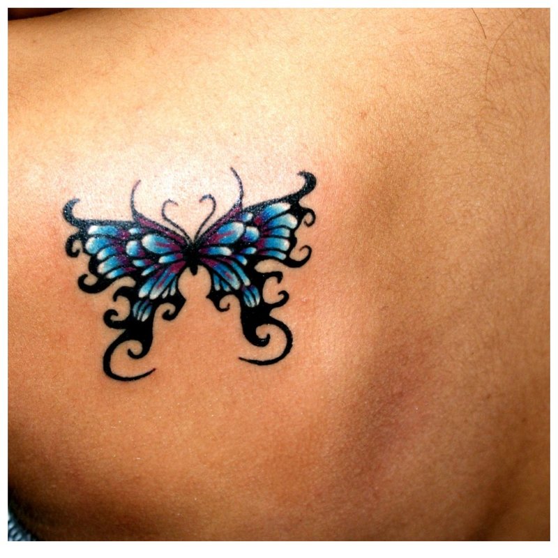 Papillon sur un tatouage à l'épaule